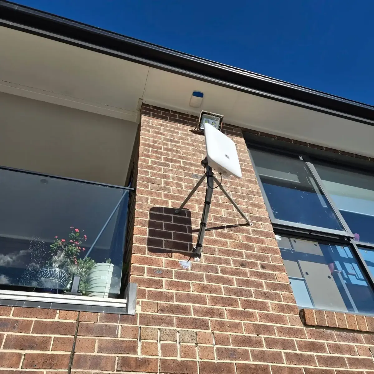A rural home with a newly installed internet antenna.